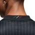 Close-up of the back of a person's neck wearing a charcoal grey shirt with three diagonal blue, white, and red stripes embroidered on the collar.