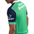 Back view of a man wearing a green sports jersey with navy blue sleeves, featuring white sponsor logos for Telcel, Suzuki, and Raloy.