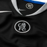 Close-up of a black Nike Chelsea FC jersey featuring a silver embroidered crest and a "90" logo inside the white-trimmed collar.