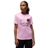 Young girl models a pink PSG jersey with Qatar Airways and Jordan logos against a solid black background.