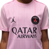 Close-up of a pink Paris Saint-Germain jersey with the Jordan Jumpman logo, the PSG club crest, and the Qatar Airways sponsor logo.