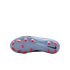 Underside view of a light blue Nike soccer cleat with bright orange studs and a black Nike swoosh, set against a solid black background.