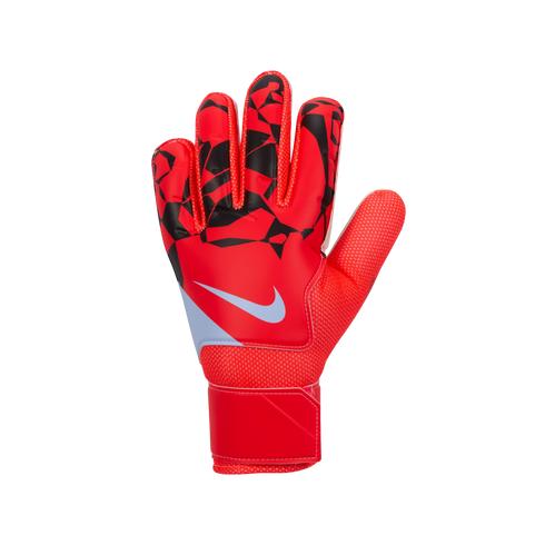 A red Nike goalkeeper glove with black geometric patterns on the fingers and a white swoosh logo, set against a solid black background.