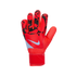 A red Nike goalkeeper glove with black geometric patterns on the fingers and a white swoosh logo, set against a solid black background.