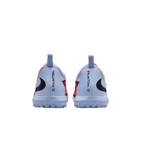 Rear view of light blue Nike Phantom soccer turf shoes with black swoosh logos and red accents against a black background.
