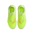 A top-down view of neon yellow Nike soccer cleats with orange accents and a slip-on design, set against a solid black background.