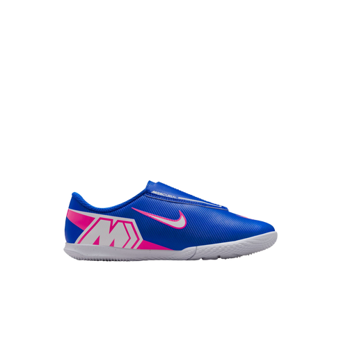 A profile view of a blue Nike Mercurial indoor soccer shoe with pink and white branding and a white flat sole, isolated on a black background.