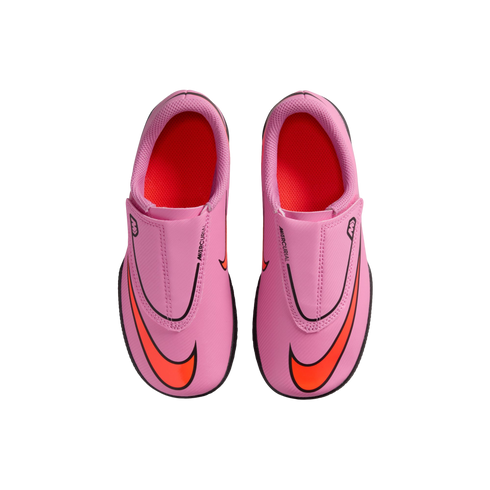 Top-down view of pink Nike Mercurial soccer cleats with bright orange swooshes and interiors, set against a solid black background.