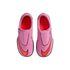 Top-down view of pink Nike Mercurial soccer cleats with bright orange swooshes and interiors, set against a solid black background.