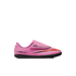A bright pink Nike Mercurial indoor soccer shoe for kids, featuring a black outsole, an orange Nike swoosh, and a hook-and-loop strap closure.