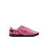 Pink Nike Mercurial indoor soccer shoe with an orange swoosh and black sole, shown in profile against a black background.