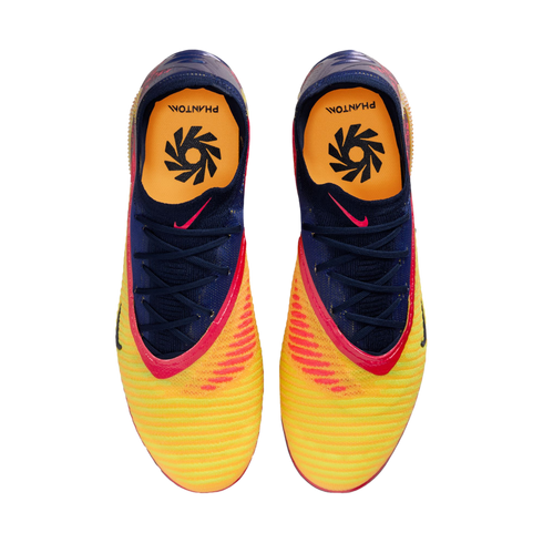 Top-down view of a pair of vibrant yellow, orange, and blue Nike Phantom football boots against a black background.