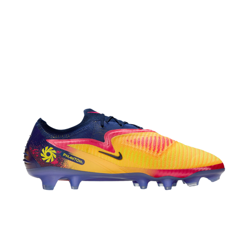 A Nike Phantom GX soccer cleat with a yellow and orange textured upper, pink accents, a navy blue collar, and purple studs against a black background.