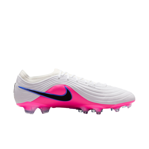 A white and bright pink Nike soccer cleat with a black swoosh and ridged texture, shown from the side against a black background.