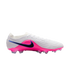 A white and bright pink Nike soccer cleat with a black swoosh and ridged texture, shown from the side against a black background.