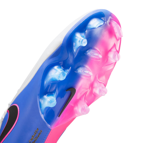 Close-up bottom view of a Nike soccer cleat featuring a vibrant blue and pink gradient soleplate with clear studs and a small black swoosh.