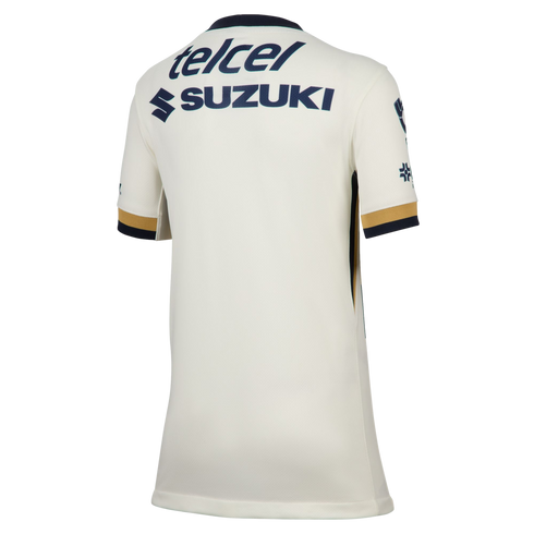 The back of a white short-sleeved soccer jersey with navy and gold sleeve trim and navy blue "telcel" and "SUZUKI" sponsor logos on the upper back.