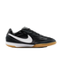 Profile view of a black Nike indoor soccer shoe with a white swoosh, white midsole, and gum outsole, set against a black background.