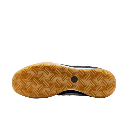 The sole of a Nike shoe featuring a gum-colored rubber outsole with a herringbone traction pattern and a central black logo.