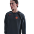 Person wearing a charcoal gray Nike sweatshirt with an orange Inter Milan crest and swoosh, against a black background.
