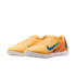 A pair of orange Nike Air Zoom indoor soccer shoes with teal swoosh logos and white outsoles, set against a black background.