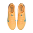 Top-down view of bright orange Nike soccer shoes with blue swooshes and Kylian Mbappé "KM" branding on the insoles.