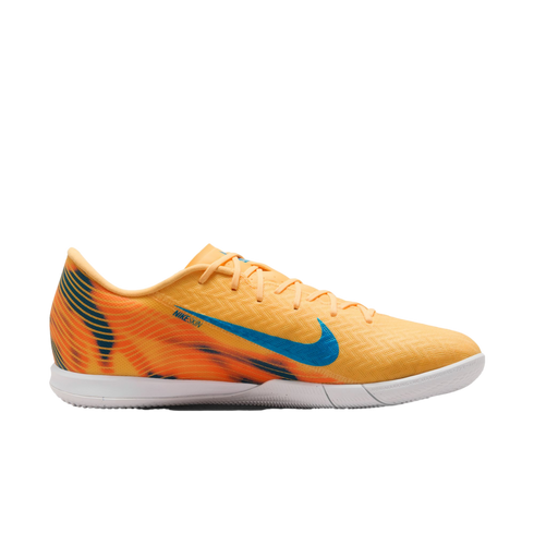 Bright orange Nike indoor soccer shoe with a blue swoosh and flame-patterned heel on a black background.