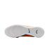 Bottom view of a white Nike soccer shoe outsole with textured tread, featuring a blue swoosh logo and glimpses of an orange upper against a black background.