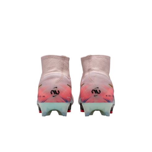 Rear view of Nike soccer cleats in pink and orange, featuring a high knit ankle collar, "NU" heel logos, and translucent outsoles.
