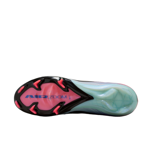 Sole of a Nike soccer cleat with a pink forefoot, blue "AIR ZOOM" text, and black/pink studs. The heel section is translucent light green.