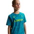 Young girl wearing a teal T-shirt with "LONDON" in neon yellow and the Tottenham Hotspur logo, against a black background.