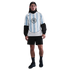 A male model wears a light blue and white striped Nike jersey over a black top, with black shorts and sneakers, posed against a plain white background.