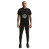 A man stands against a black background wearing a black Nike USA soccer training uniform featuring a large white Volkswagen logo on the shirt.