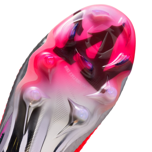 Close-up of a pink and silver Nike soccer cleat soleplate, featuring "NIKE CYCLONE 360" branding and various traction studs.