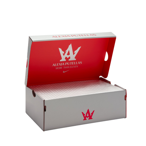 Open white and red Nike shoebox for soccer player Alexia Putellas, featuring her personal logo and slogan "More Than Eleven" inside the lid.