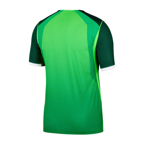 Back view of a bright green short-sleeved athletic jersey with dark patterned shoulders and white cuff bands on a solid black background.