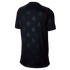 Back view of a black short-sleeved jersey with a subtle tonal star pattern and thin red piping along the seams, set against a black background.