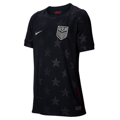 A dark navy Nike USA soccer jersey with a subtle tonal star pattern, featuring the white national team crest, Nike swoosh, and thin red accents.