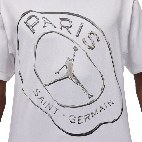White t-shirt with a large, liquid-metal style silver graphic featuring "PARIS SAINT-GERMAIN" text surrounding the iconic Jordan Jumpman logo.