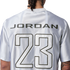 Back of a white jersey with "JORDAN" and a large number "23" printed in black and white.