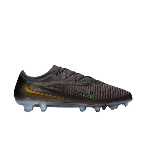 A side view of a dark charcoal Nike soccer cleat featuring iridescent green and gold swooshes and a textured, ribbed upper, set against a solid black background.