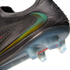 Close-up of a black Nike soccer cleat with an iridescent green swoosh, textured upper, and translucent blue sole with clear studs.