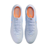 Top-down view of a pair of light blue Nike Tiempo soccer cleats with orange insoles, set against a solid black background.