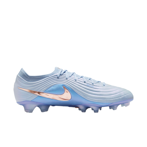 A light blue Nike soccer cleat featuring a metallic rose gold swoosh, textured upper, and translucent blue studs, set against a black background.