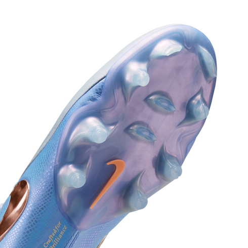 Close-up of a light blue Nike soccer cleat's translucent purple soleplate with clear studs and an orange swoosh logo.