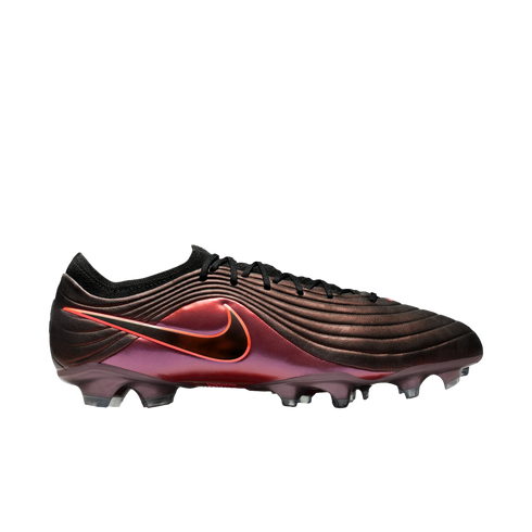 A side view of a Nike soccer cleat with an iridescent purple and bronze upper, wavy grooves, a red Nike swoosh, and translucent studs on a black background.