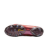 Bottom view of an iridescent maroon Nike soccer cleat soleplate with clear studs, a yellow swoosh, and "Crafted for Brilliance" text, set against a solid black background.