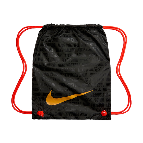 Black Nike drawstring bag with bright orange straps and a large gold swoosh. Features a repeating tonal pattern of "Nike" and "football" in various languages.