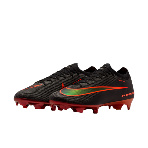 A pair of black Nike Air Zoom soccer cleats with red soleplates and a gradient green-to-orange Swoosh logo, shown against a solid black background.