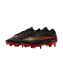 A pair of black Nike Air Zoom soccer cleats with red soleplates and a gradient green-to-orange Swoosh logo, shown against a solid black background.